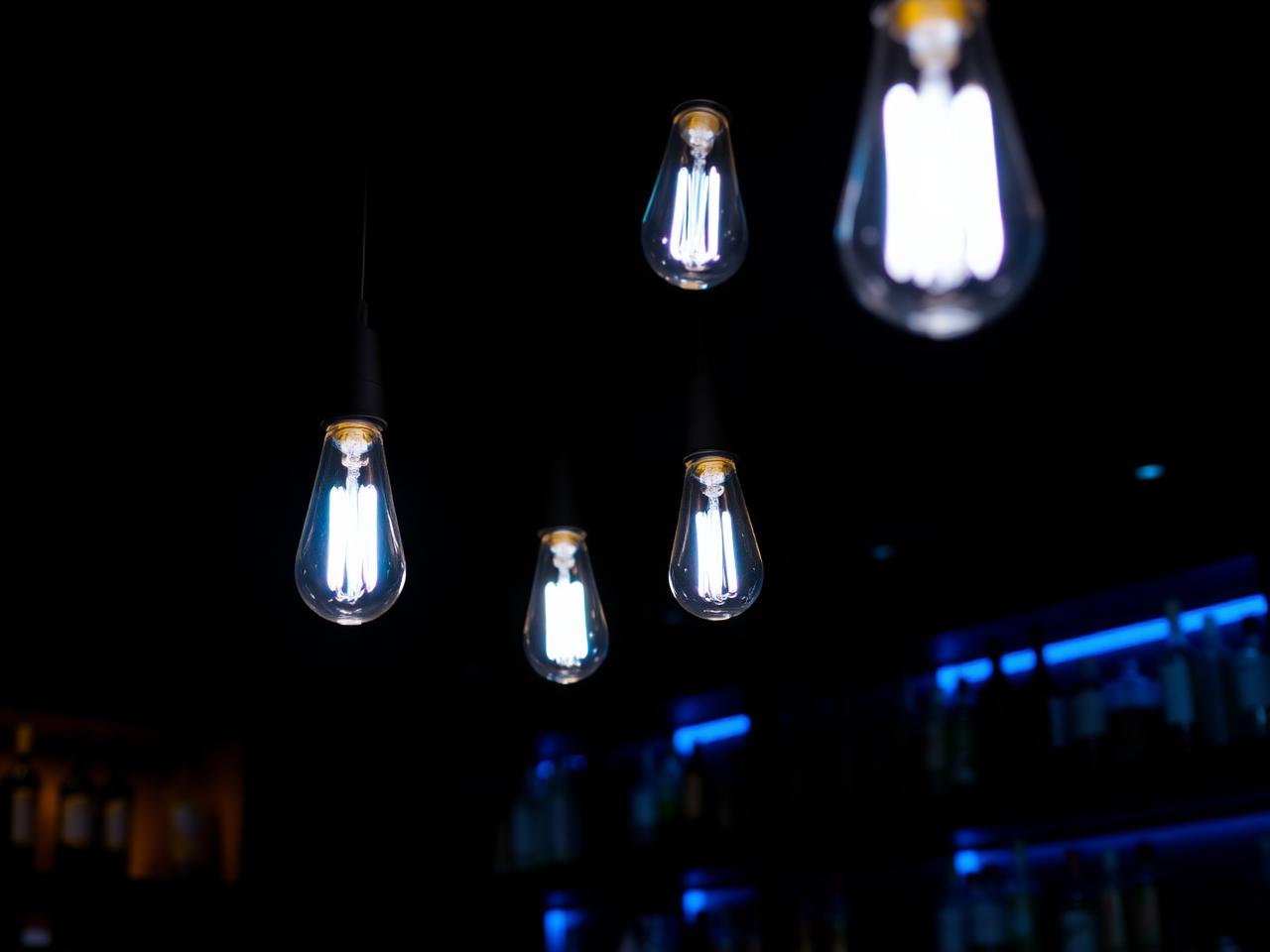 Modern bar lit with blue Edison bulbs